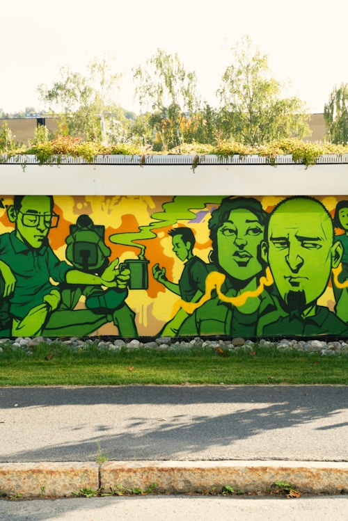 Foto av flere fjes som er tegnet på grafittiveggen.