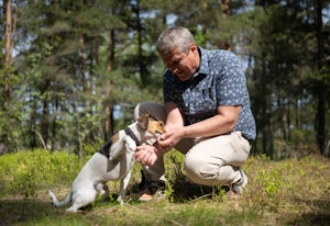 Foto av kjøperen Tor Helge med hunden sin i skogen.