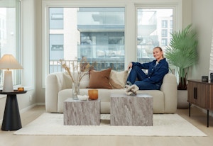 Stylisten fra Bohus sitter i en hvit sofa i en leilighet i MIDT.